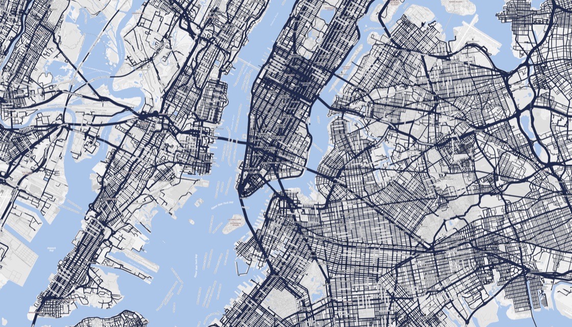 A dense city road network carrying modelled traffic, every street drawn in proportion to its volume